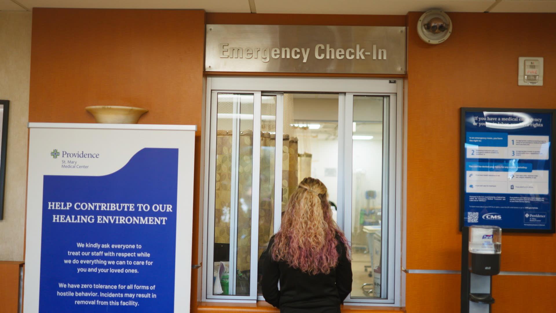 Woman standing at check-in window at St. Mary's Medical Center